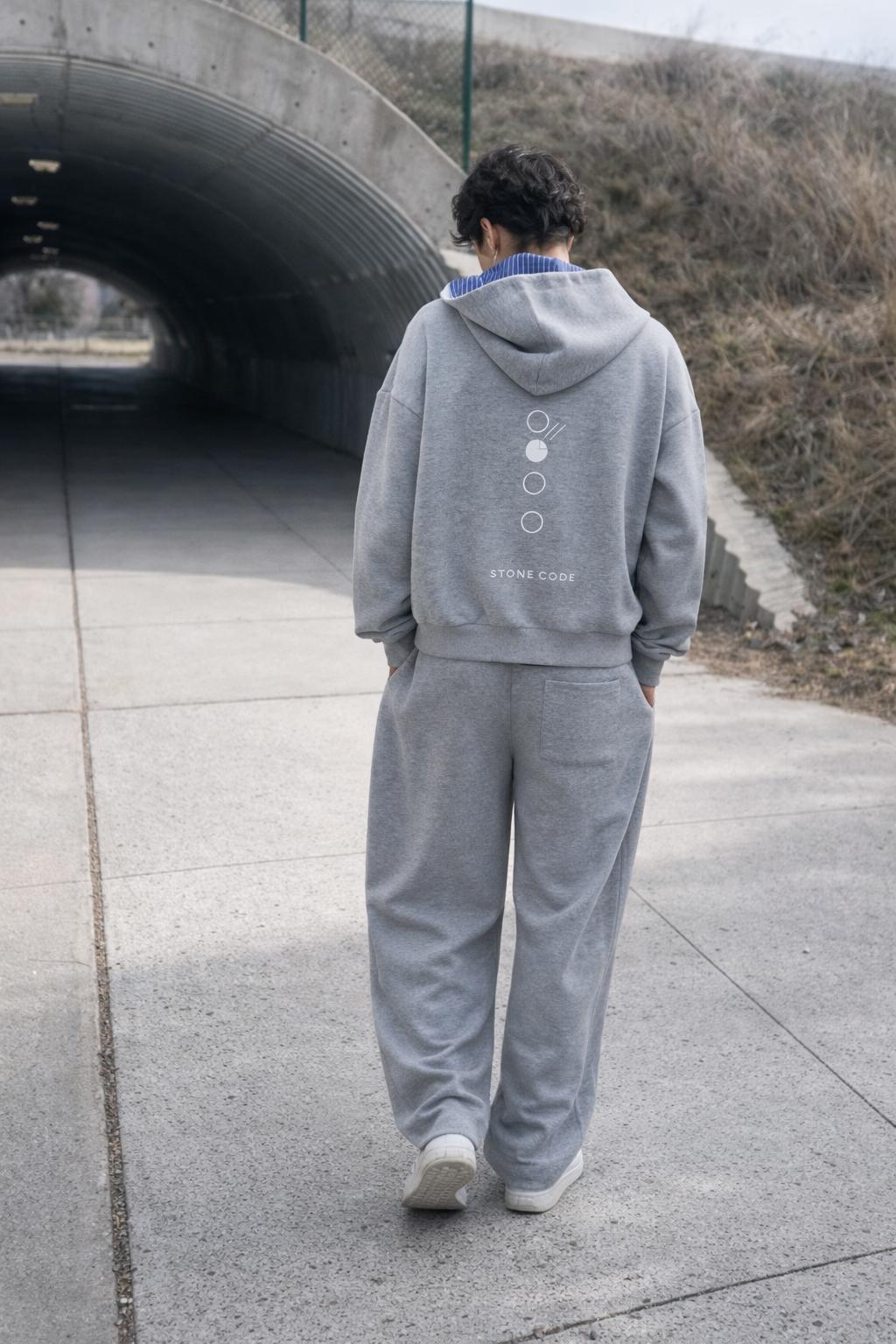 Unisex gray oversized hoodie and sweatpants set with "STONE CODE" graphic on back.