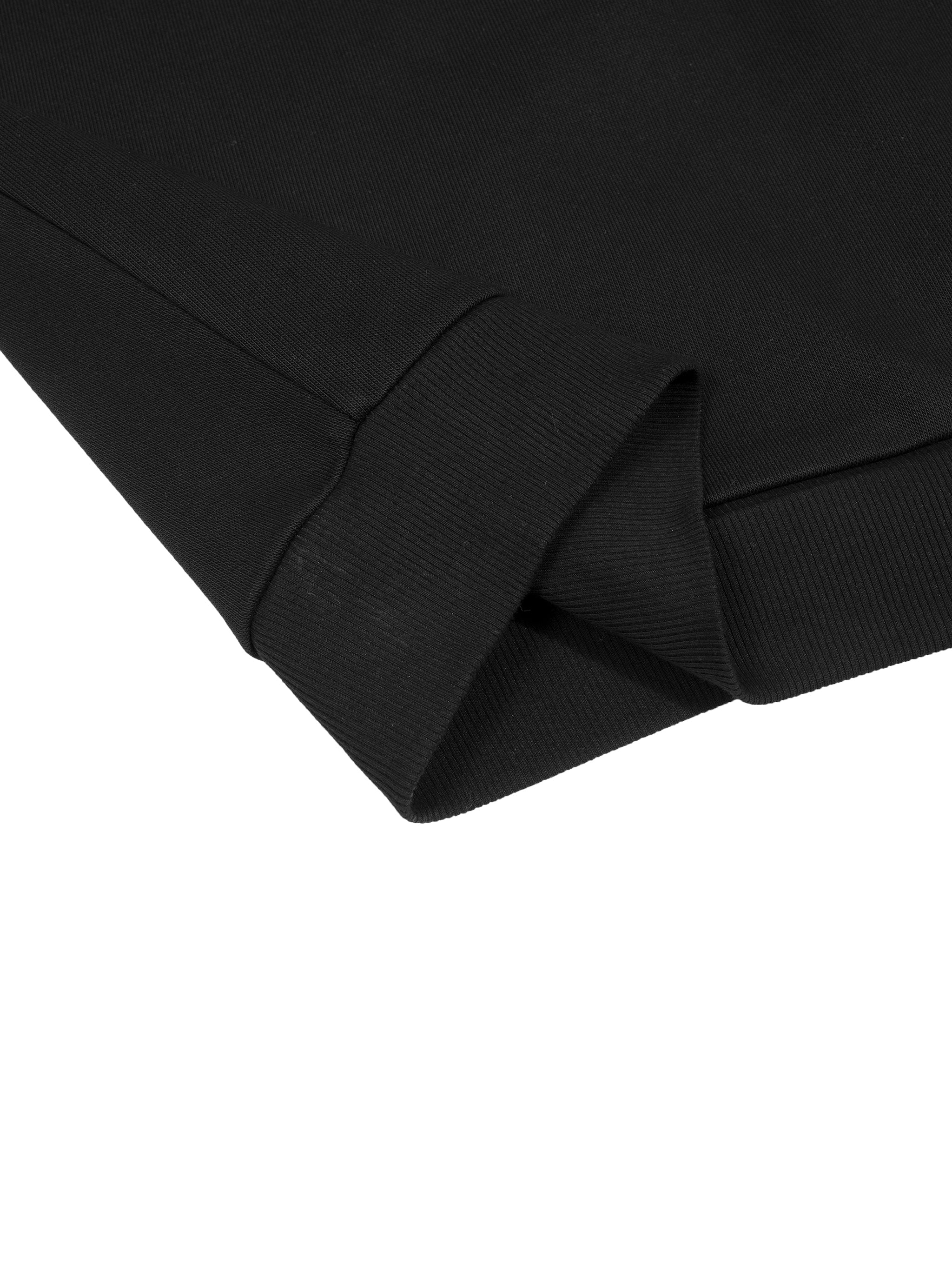 Close-up of a black cotton blend long sleeve with ribbed cuff.