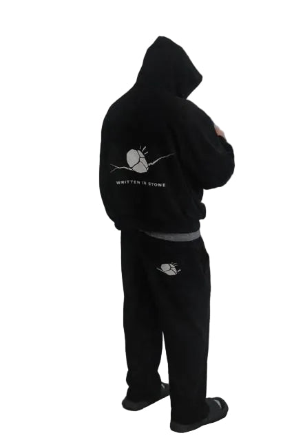 Unisex oversized black raglan hoodie and sweatpants with "Written in Stone" graphic.