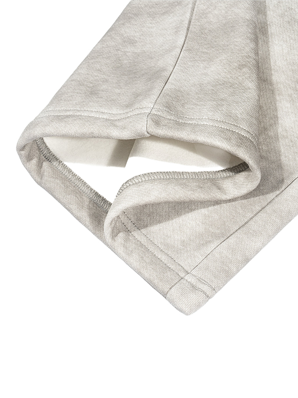 Close-up of a grey dirty washed fleece sweatpant cuff, showing the loose fit and cotton blend fabric.
