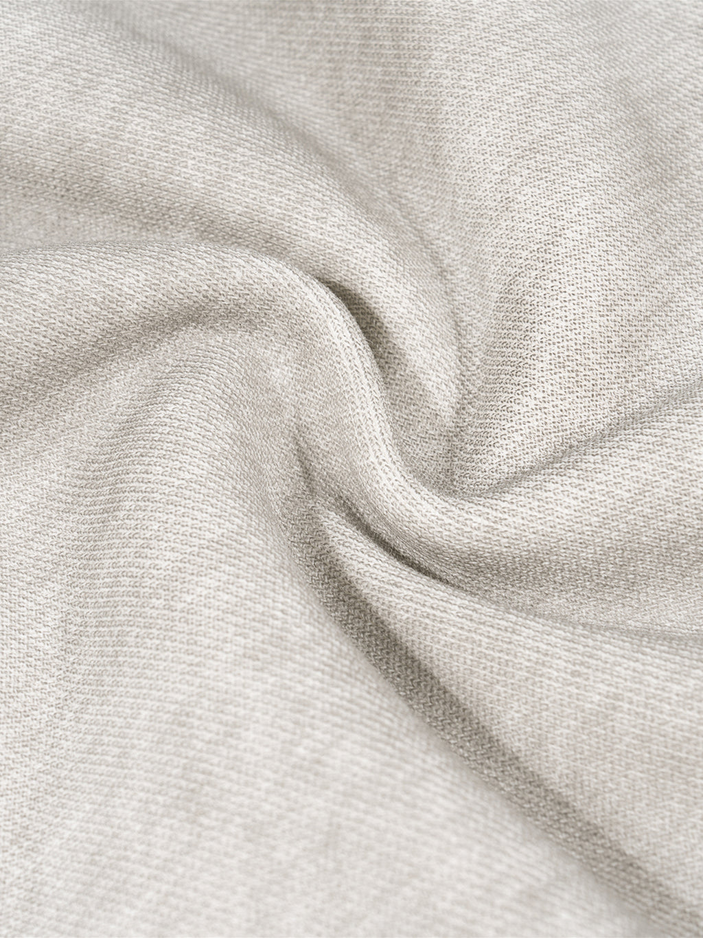 Close-up of dirty washed grey fleece sweatpant fabric, showing soft texture and subtle wrinkles.