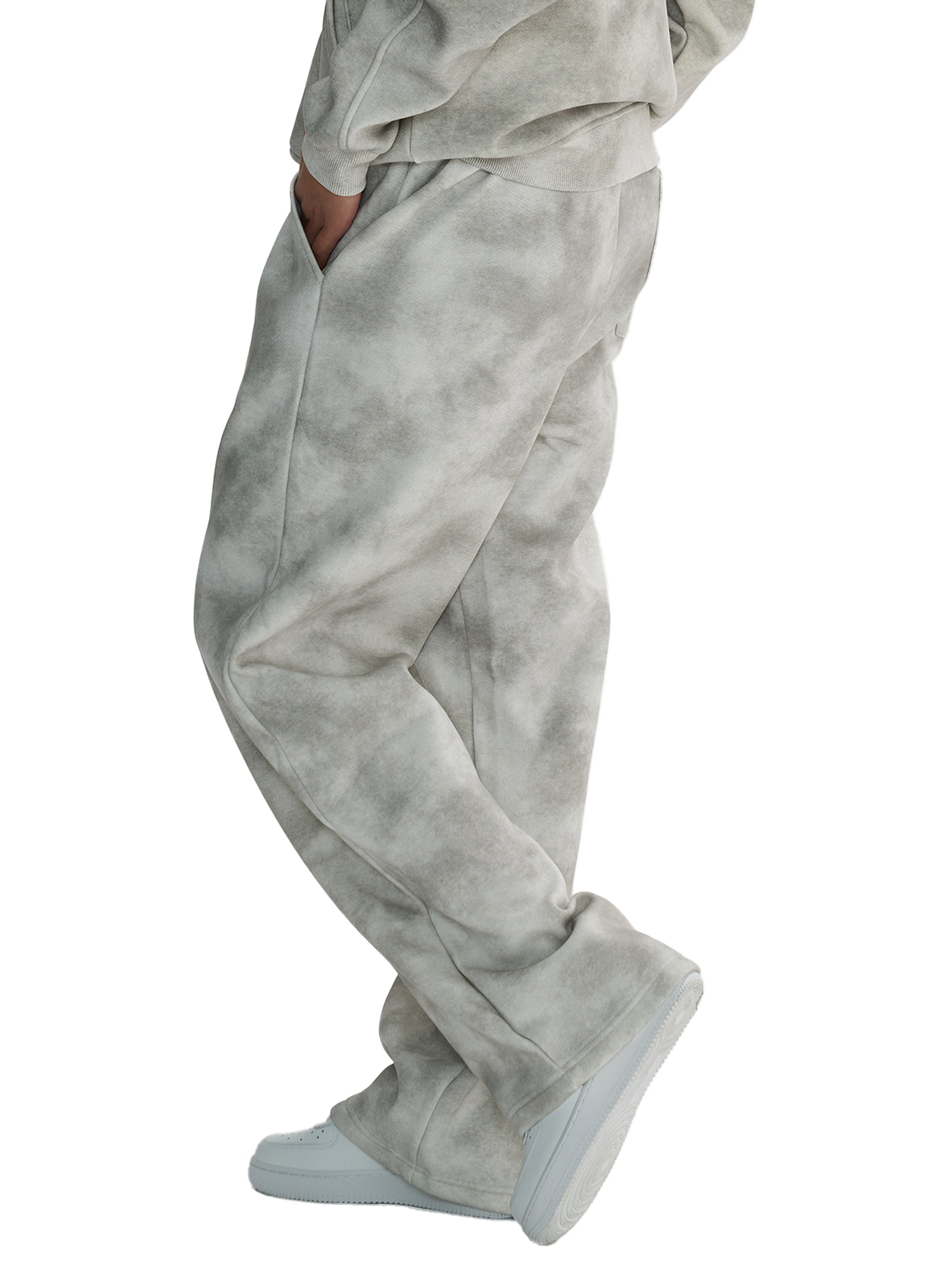 Unisex dirty washed fleece sweatpants in grey, featuring a loose fit and mid-waist with a drawstring.