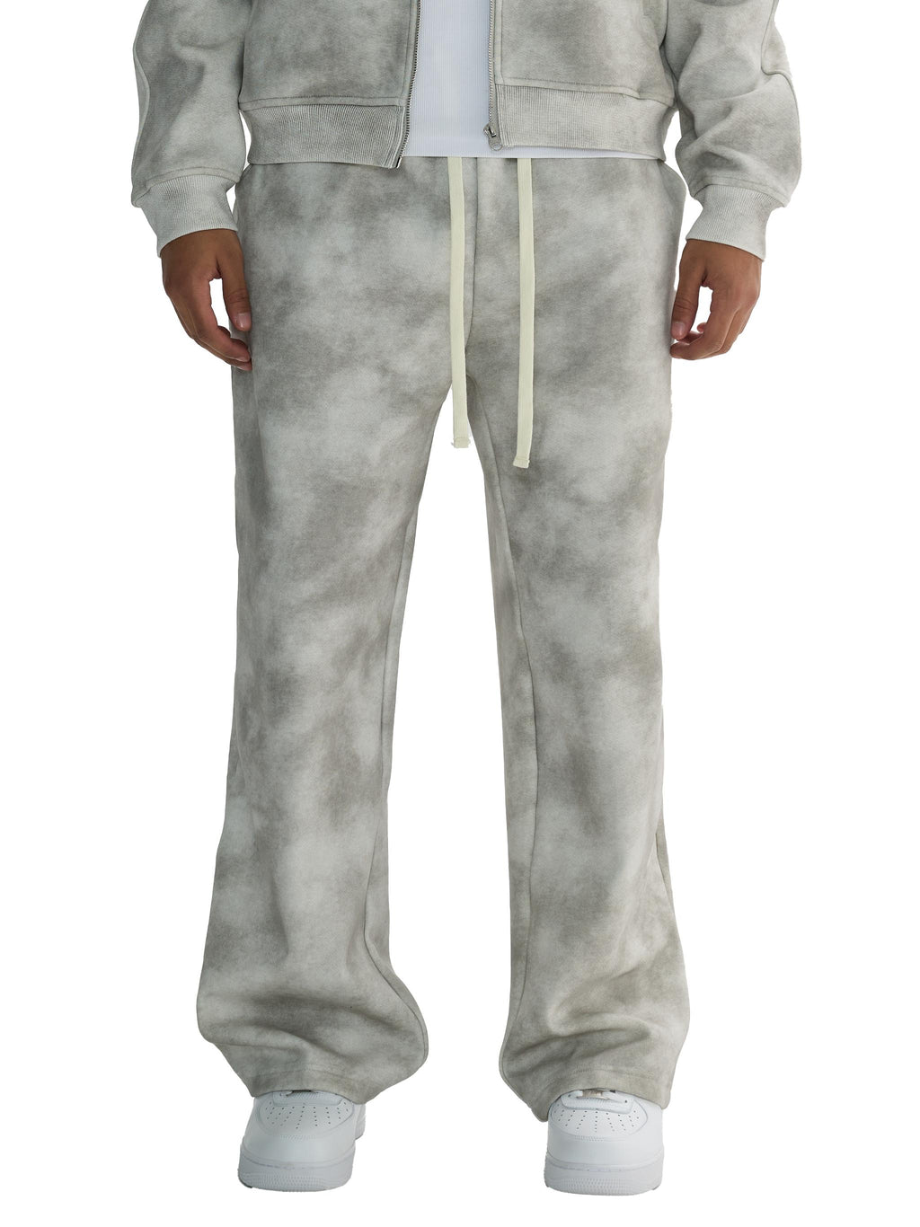 Unisex dirty washed grey fleece sweatpants with cream drawstrings, paired with a matching hoodie and white sneakers.