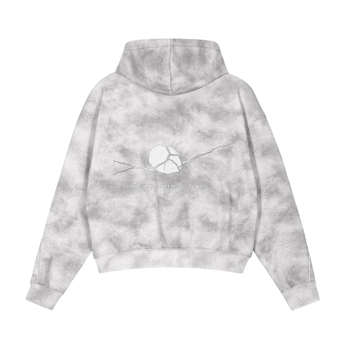 Back of a grey dirty washed zip-up fleece hoodie with a cracked stone graphic and "WRITTEN IN STONE" text.