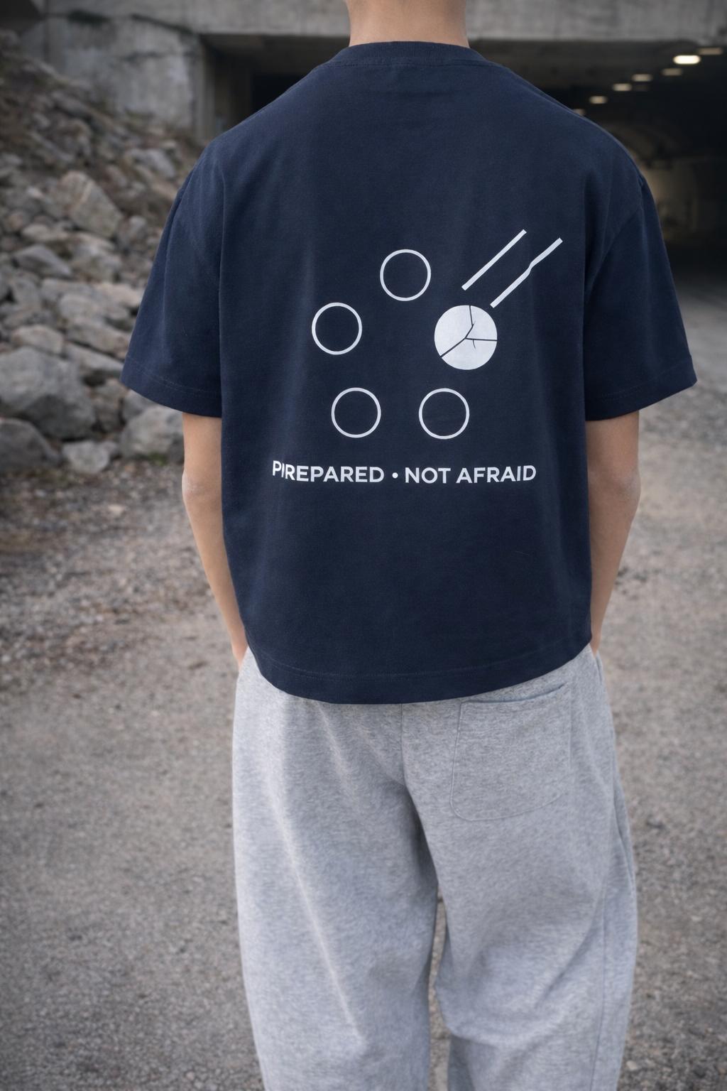 Unisex navy blue cotton boxy t-shirt with white "Prepared Not Afraid" graphic on back.