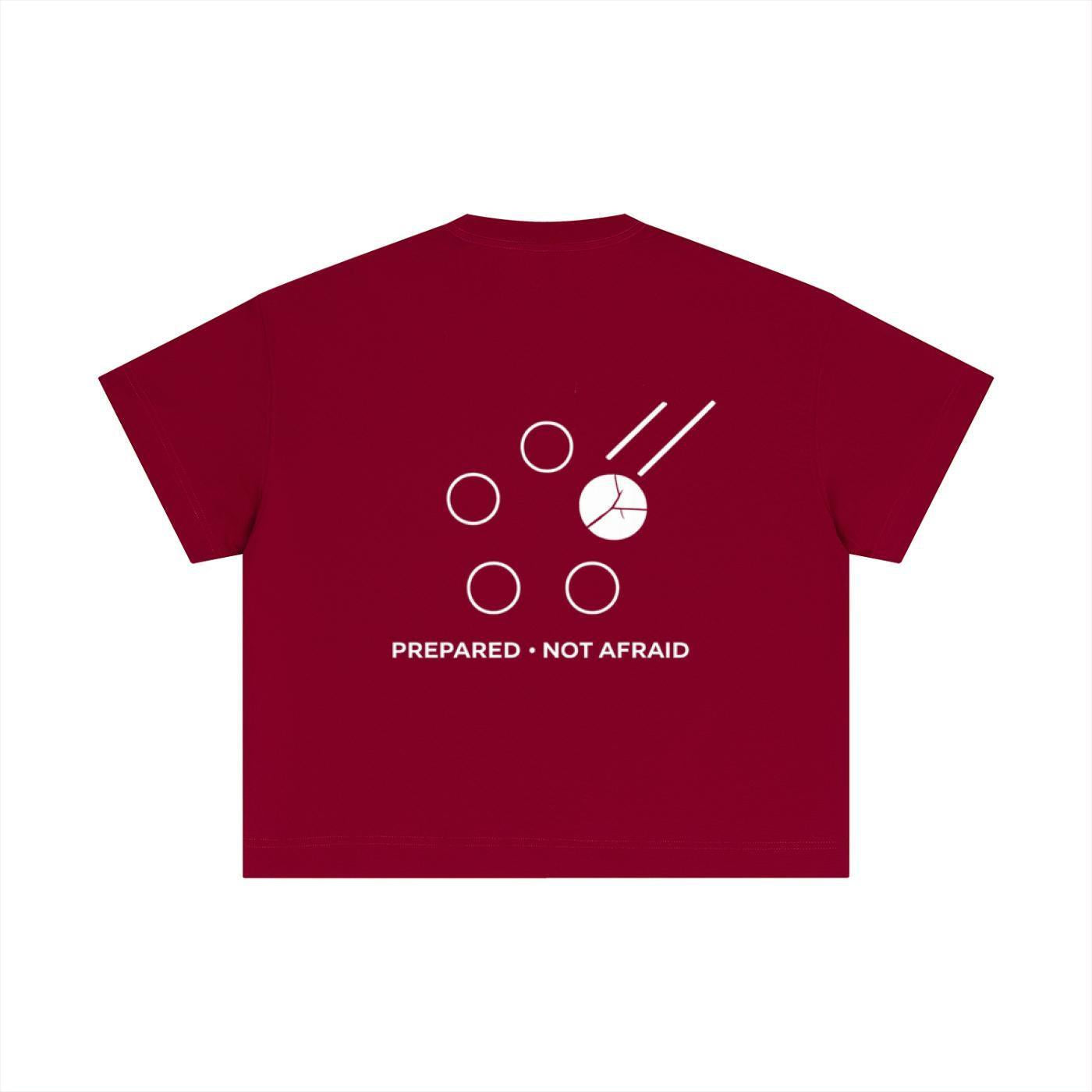 Red essential cotton boxy t-shirt with white "PREPARED • NOT AFRAID" graphic and abstract design.