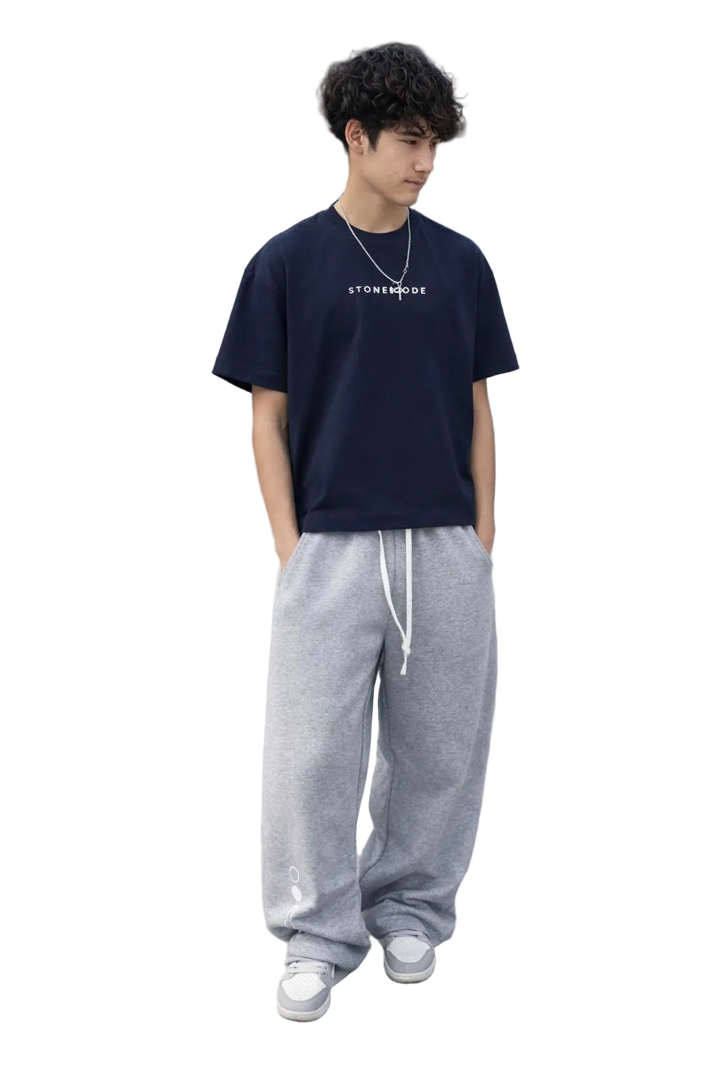 Young man wearing a navy blue Essential Cotton Boxy T-Shirt with white "STONEMODE" text and gray sweatpants.