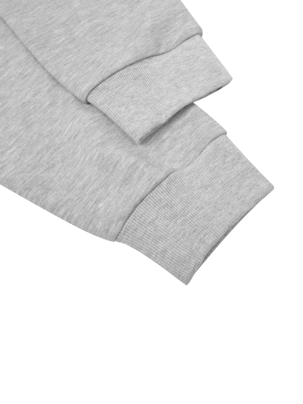 Close-up of a light grey cotton blend cropped hoodie sleeve with ribbed cuff.