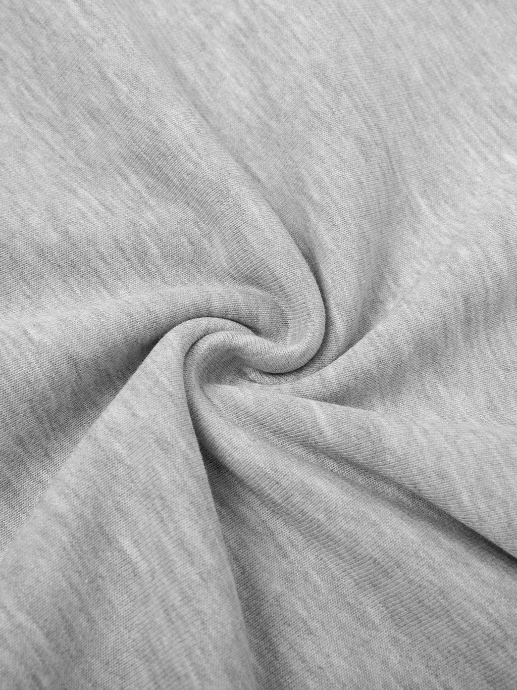 Close-up of light gray cotton blend fabric, showing soft texture and gentle folds.