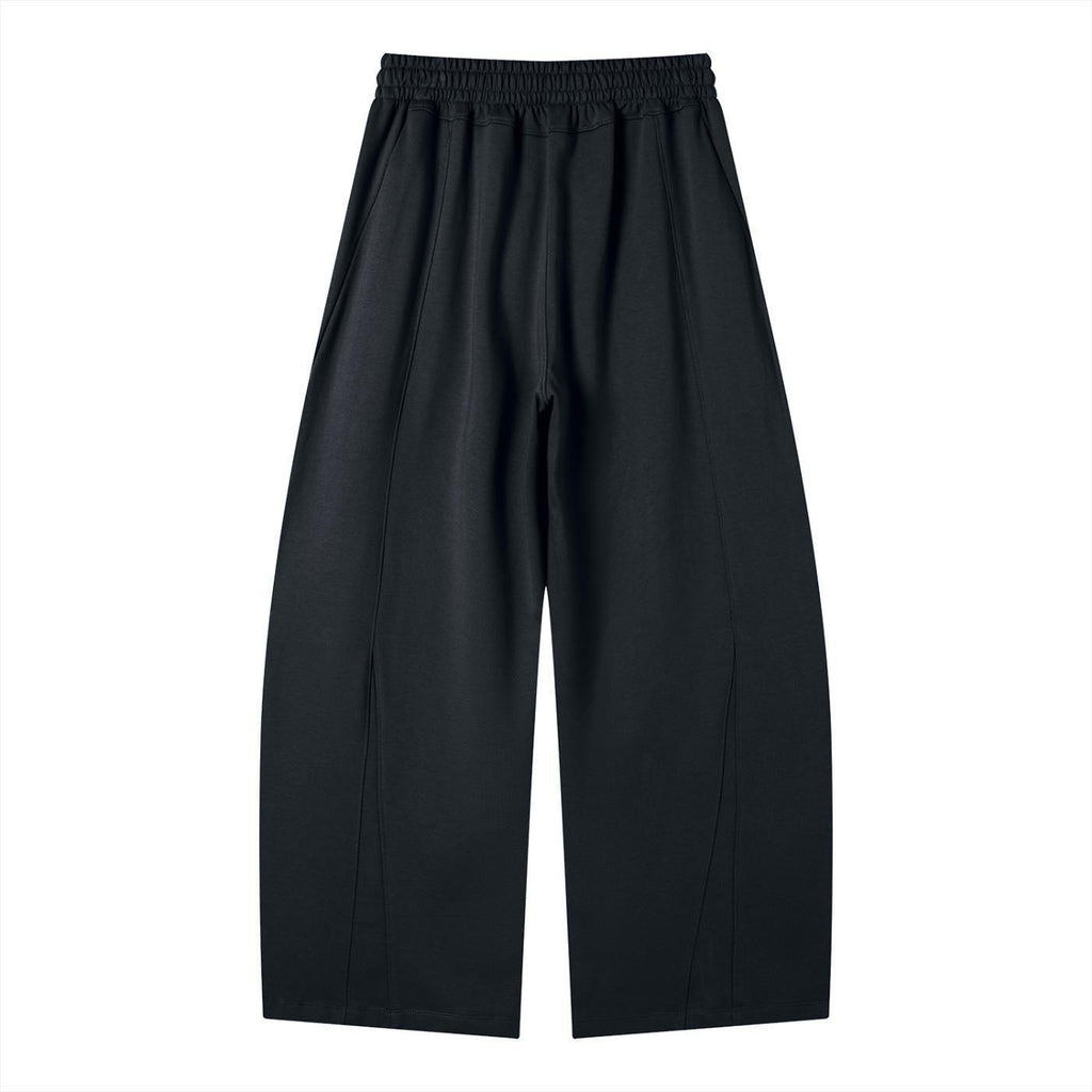 Black heavyweight wide leg panel sweatpants with an elastic waistband and visible seams.