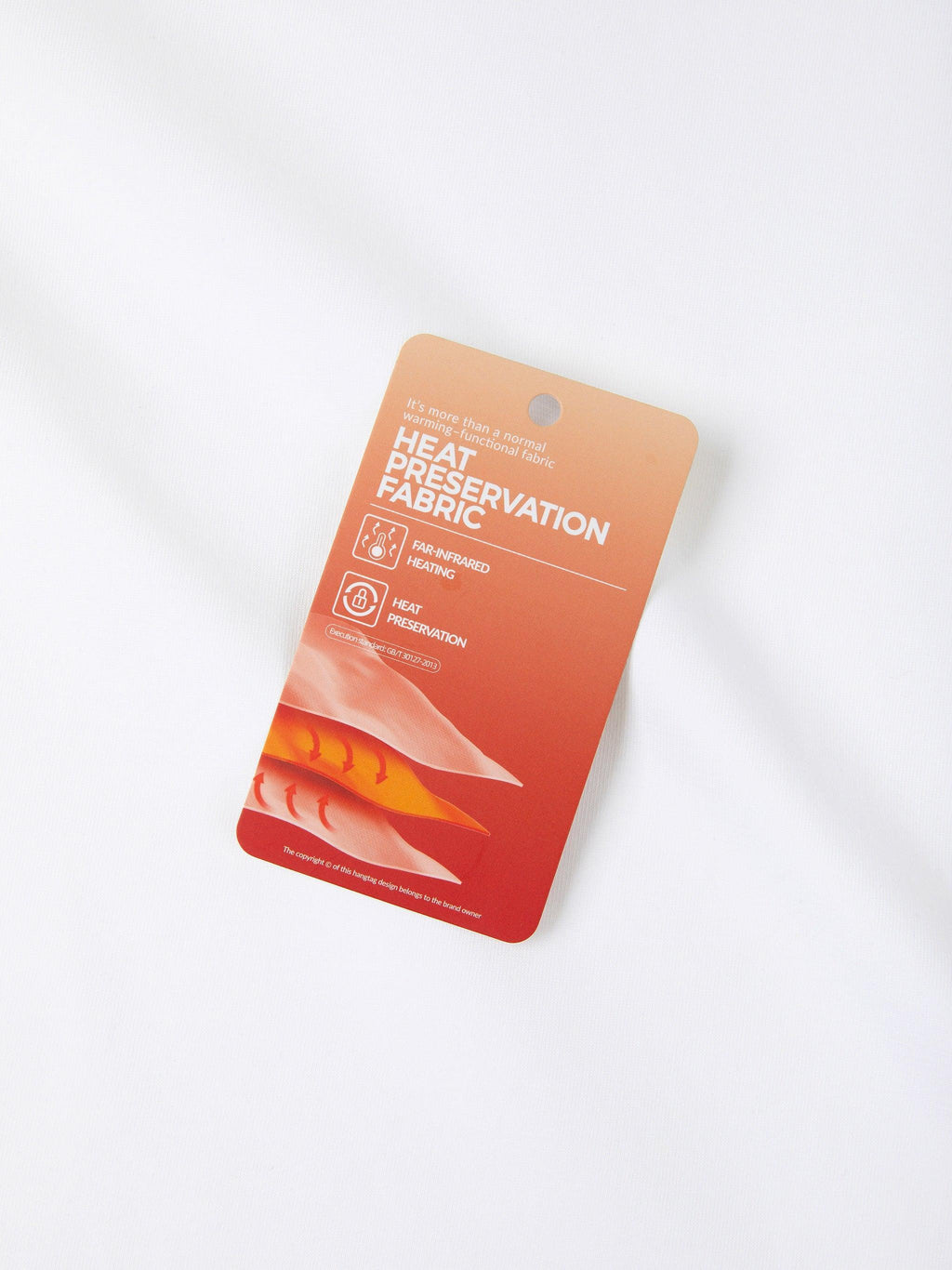 Orange and red "Heat Preservation Fabric" hang tag with icons for far-infrared heating and heat preservation.