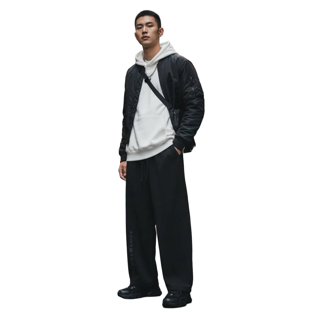 Unisex model wearing black heavyweight wide leg panel sweatpants with a drawstring and elastic waist.