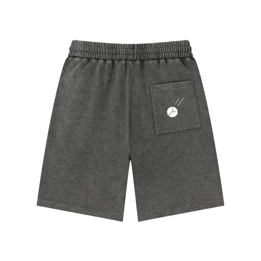 Mineral wash waffle knit shorts in dark gray with an elastic waist, back pocket, and white graphic.