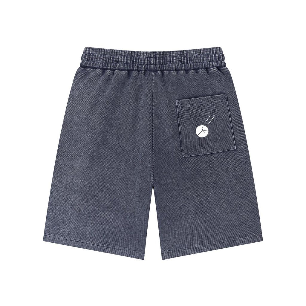 Mineral wash waffle knit shorts in dark gray with an elastic drawstring waist and a back pocket featuring a white graphic.