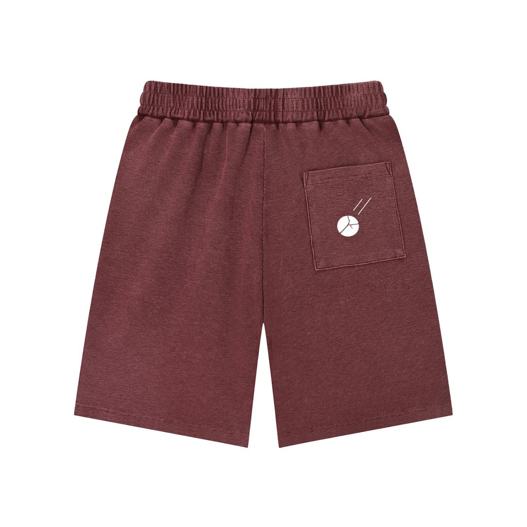 Mineral wash waffle knit shorts in maroon with an elastic drawstring waist and a white Sputnik graphic on the back pocket.