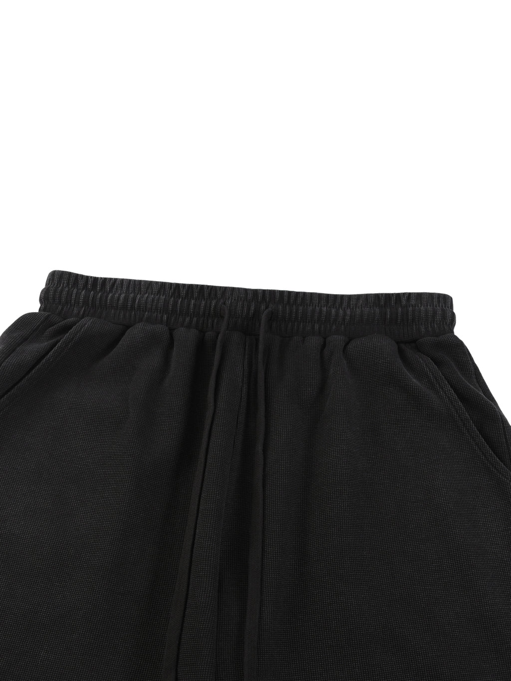 Black mineral wash waffle knit shorts with drawstring waist.