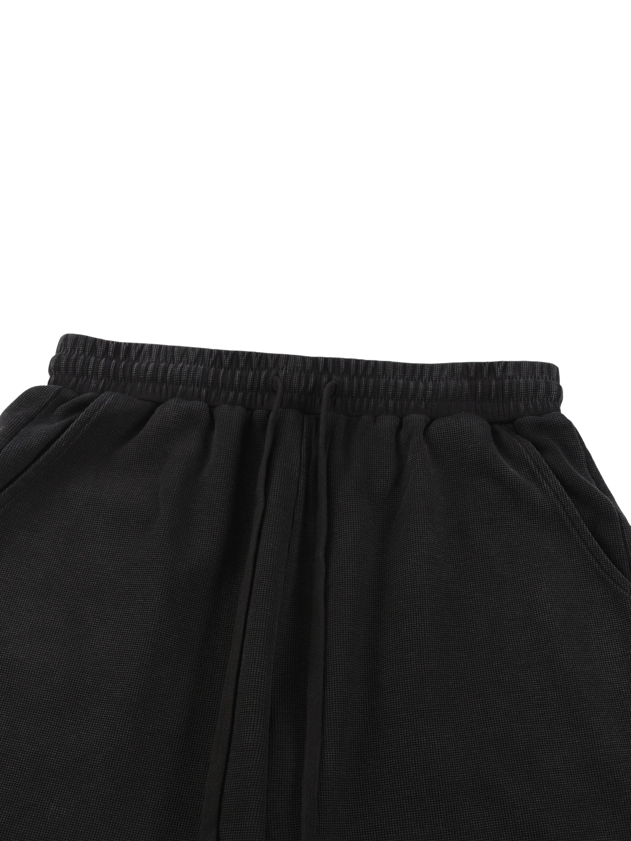 Black mineral wash waffle knit shorts with drawstring waist.