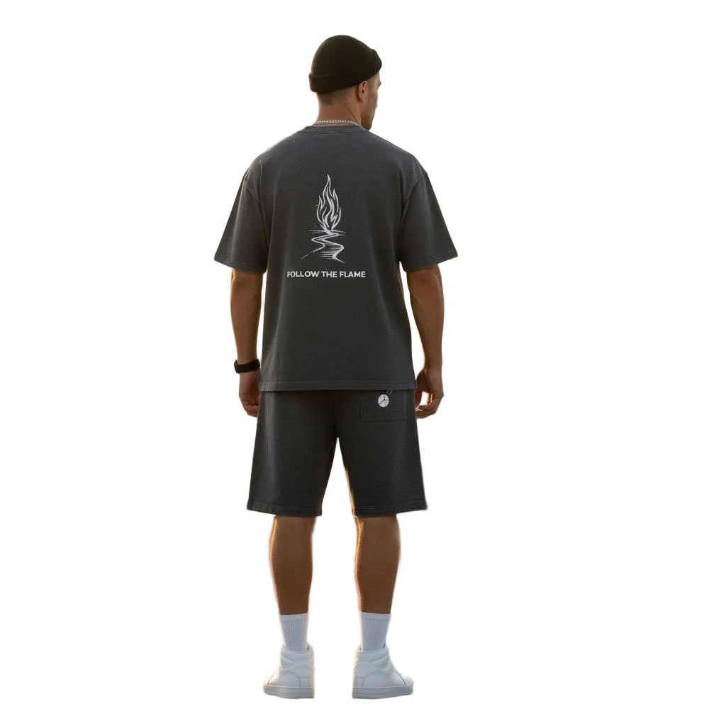 Unisex mineral wash waffle knit shorts and matching t-shirt with "Follow the Flame" graphic, worn by a model from behind.