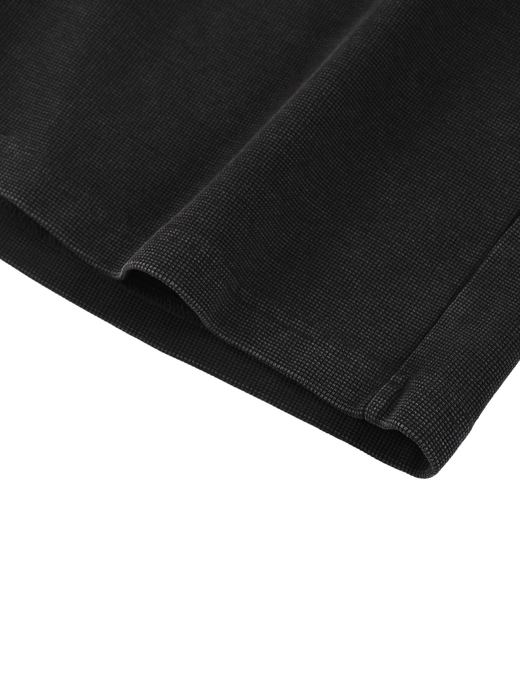 Close-up of dark mineral wash waffle knit shorts, showing textured fabric and hem detail.