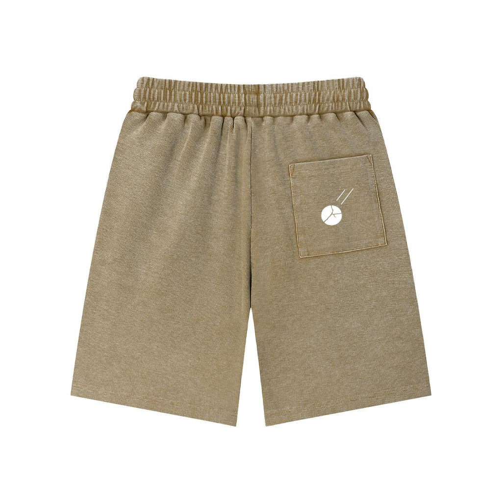 Mineral wash waffle knit shorts in a warm brown hue, featuring an elastic waistband and a back pocket with a white graphic.