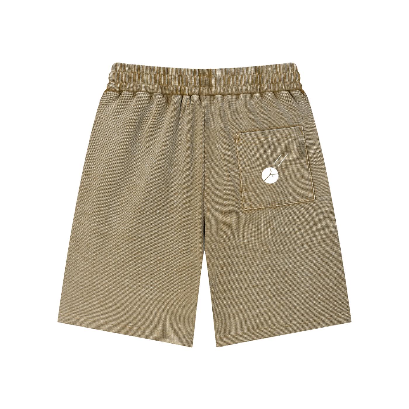 Mineral wash waffle knit shorts in a warm brown hue, featuring an elastic waistband and a back pocket with a white graphic.