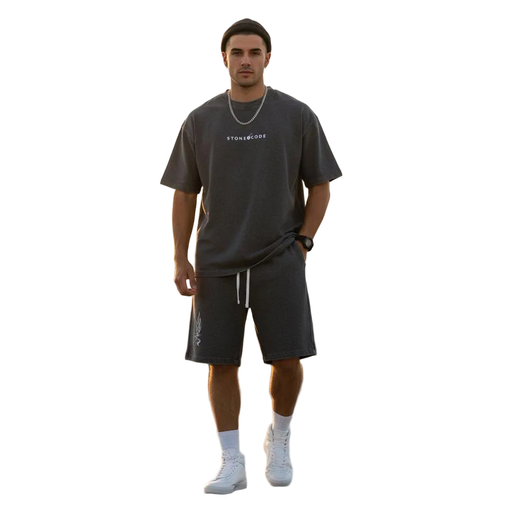 Unisex mineral wash waffle knit shorts and matching t-shirt on a model, featuring a drawstring and loose fit.