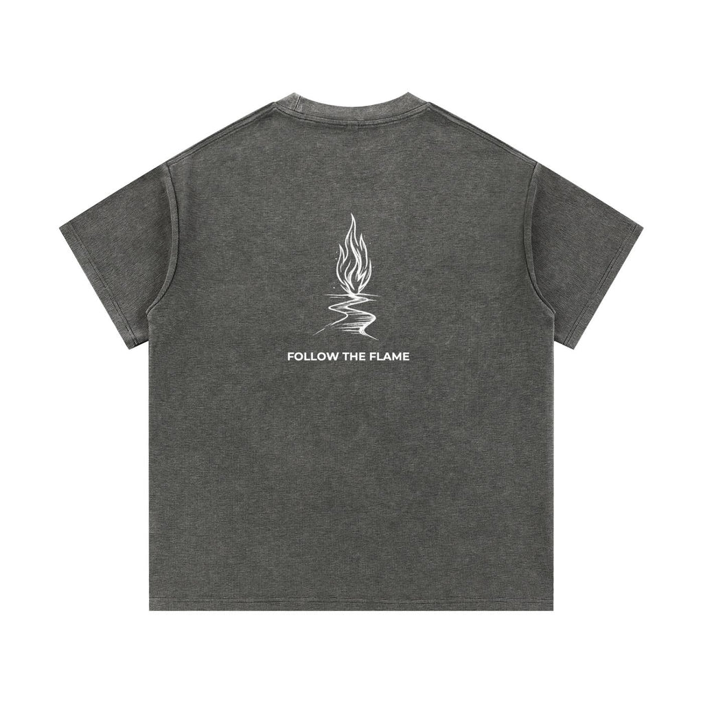 Mineral wash waffle knit t-shirt in dark gray with "FOLLOW THE FLAME" graphic on the back.