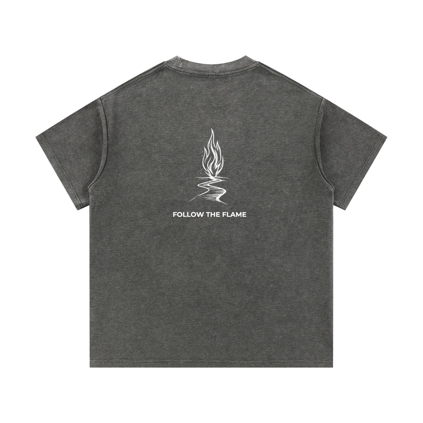 Mineral wash waffle knit t-shirt in dark gray with "FOLLOW THE FLAME" graphic on the back.
