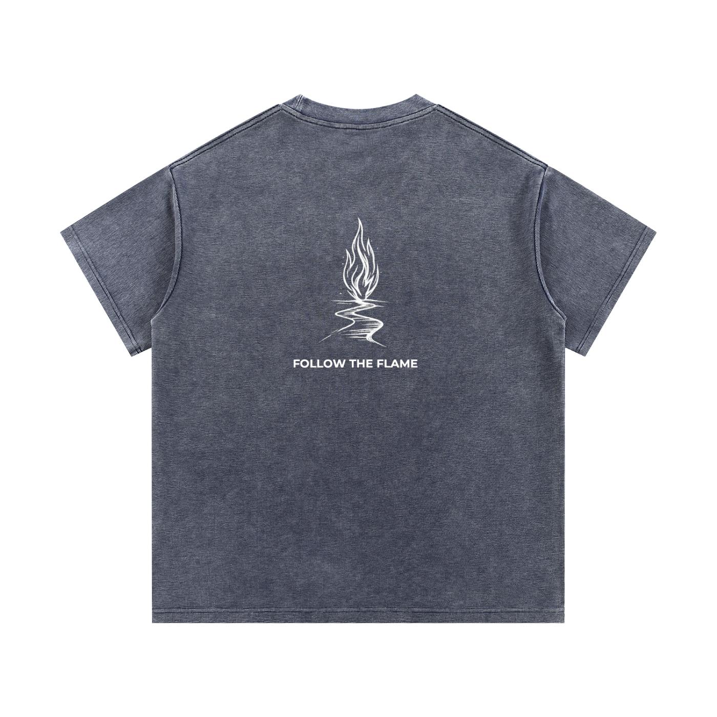 Mineral wash waffle knit t-shirt in dark gray with a white "Follow the Flame" graphic on the back.