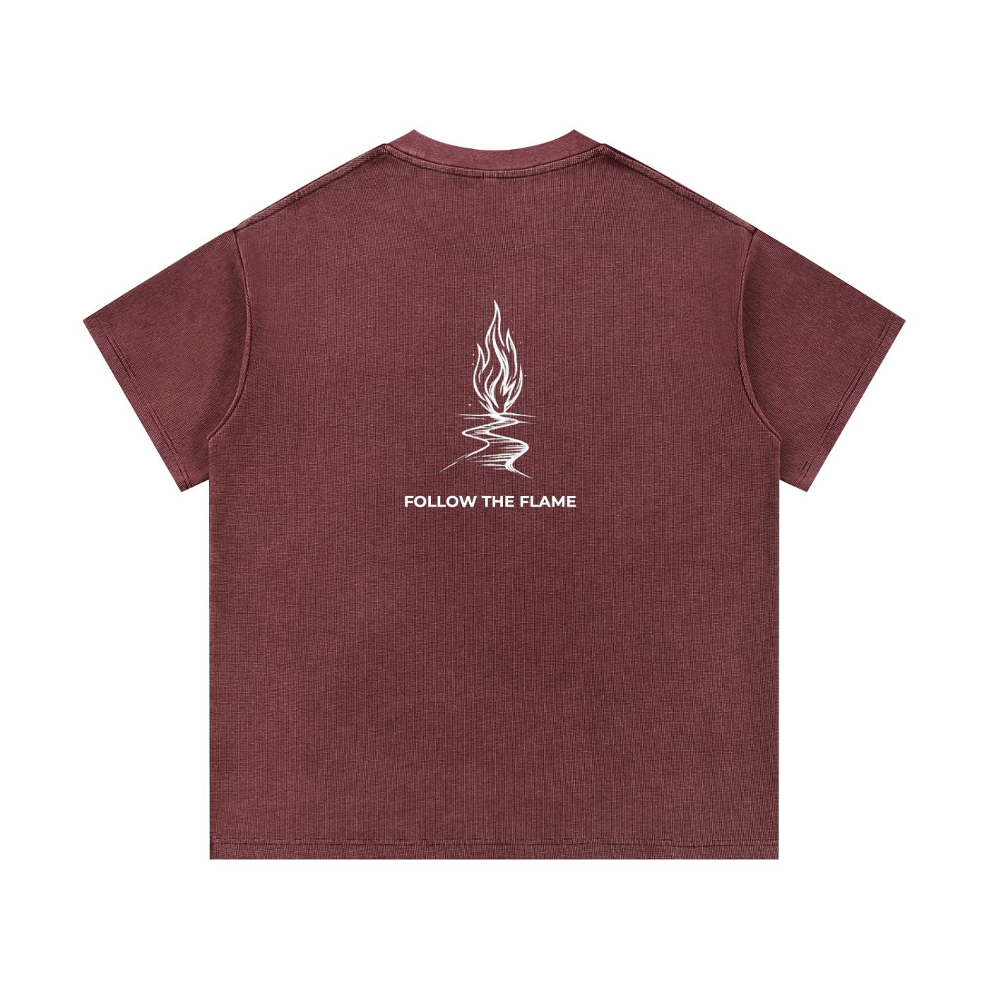 Mineral wash waffle knit t-shirt in dark red with a white "Follow the Flame" graphic on the back.
