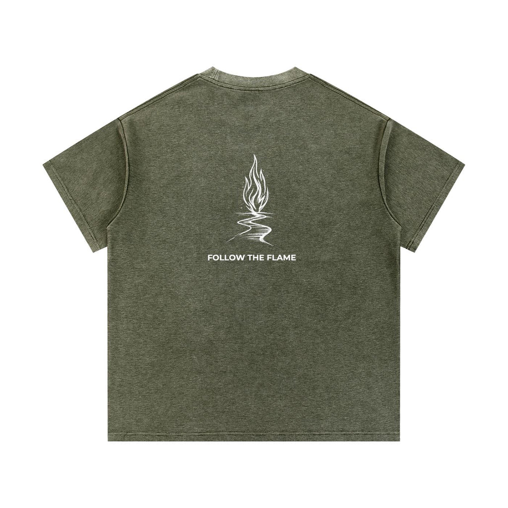 Mineral wash waffle knit t-shirt in olive green with a white flame graphic and "FOLLOW THE FLAME" text on the back.