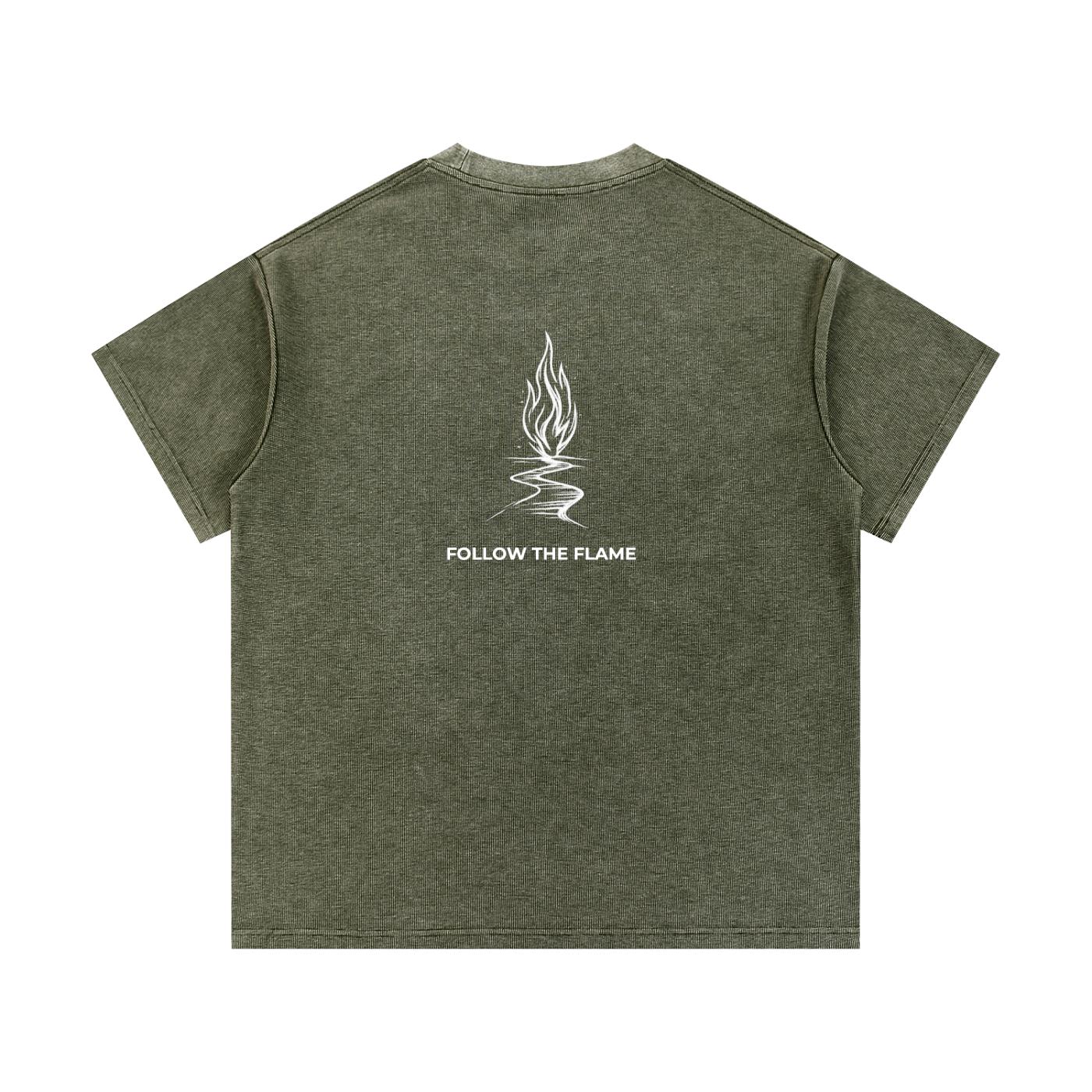 Mineral wash waffle knit t-shirt in olive green with a white flame graphic and "FOLLOW THE FLAME" text on the back.