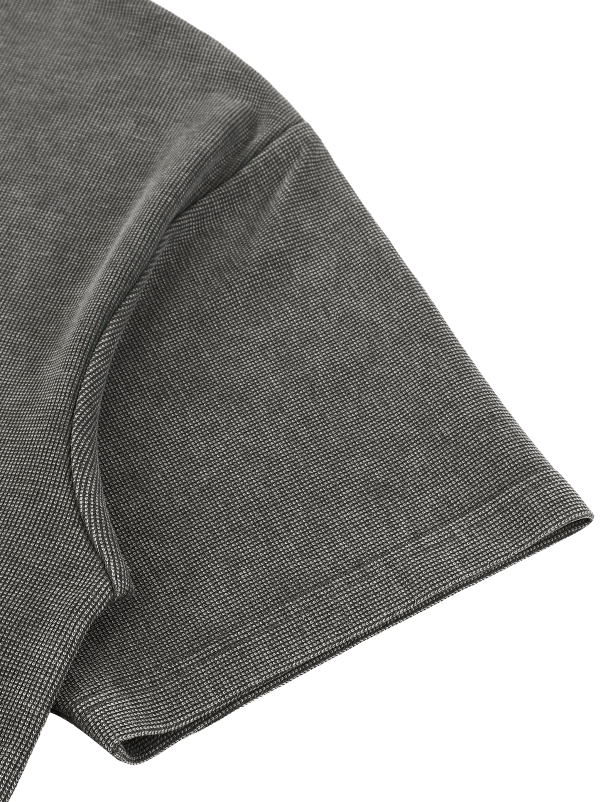 Close-up of a dark gray mineral wash waffle knit t-shirt sleeve with a drop shoulder.