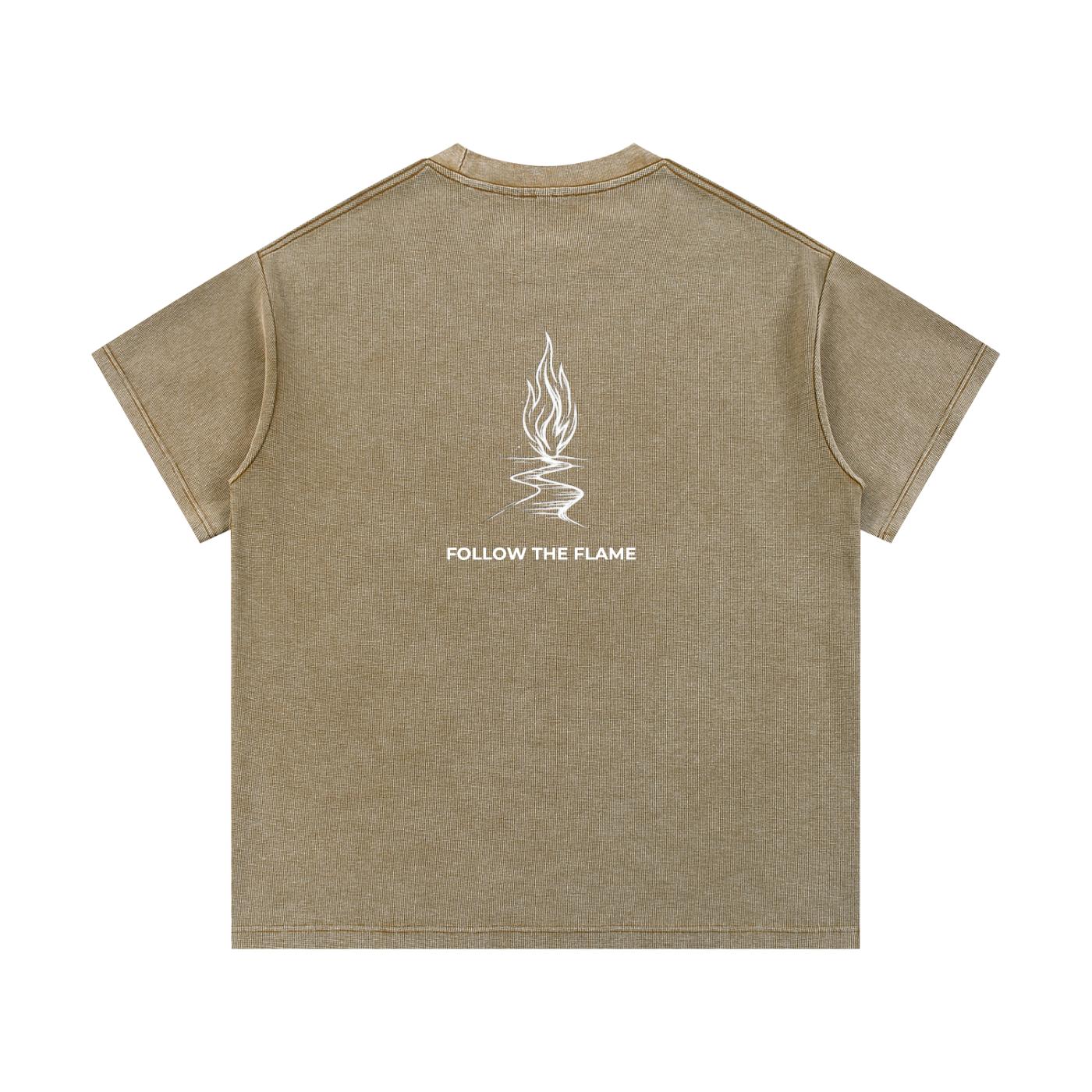 Back of a loose-fit mineral wash waffle knit t-shirt in brown with a white "FOLLOW THE FLAME" graphic.