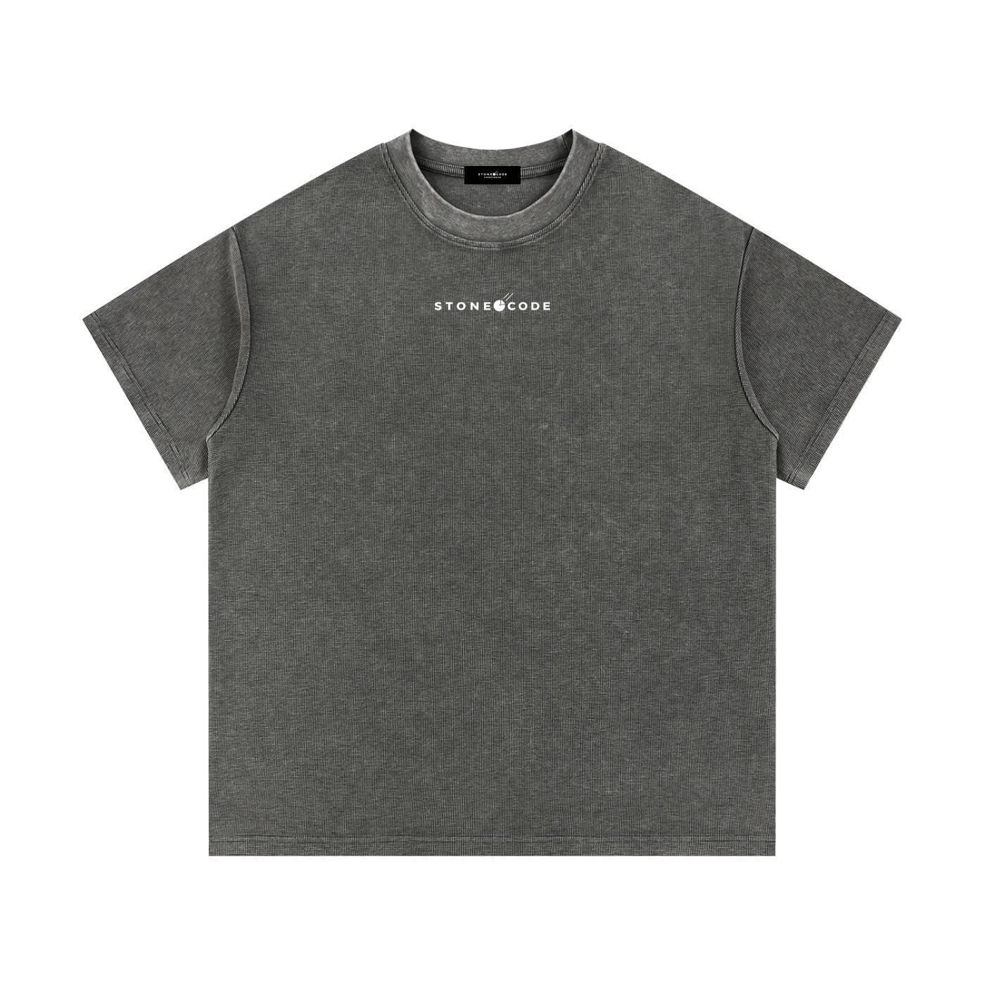 Mineral wash waffle knit t-shirt in dark gray with a white "STONE CODE" logo, short sleeves, and round neck.