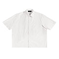 White oversized boxy shirt with subtle vertical stripes, short sleeves, lapel collar, and a chest pocket.
