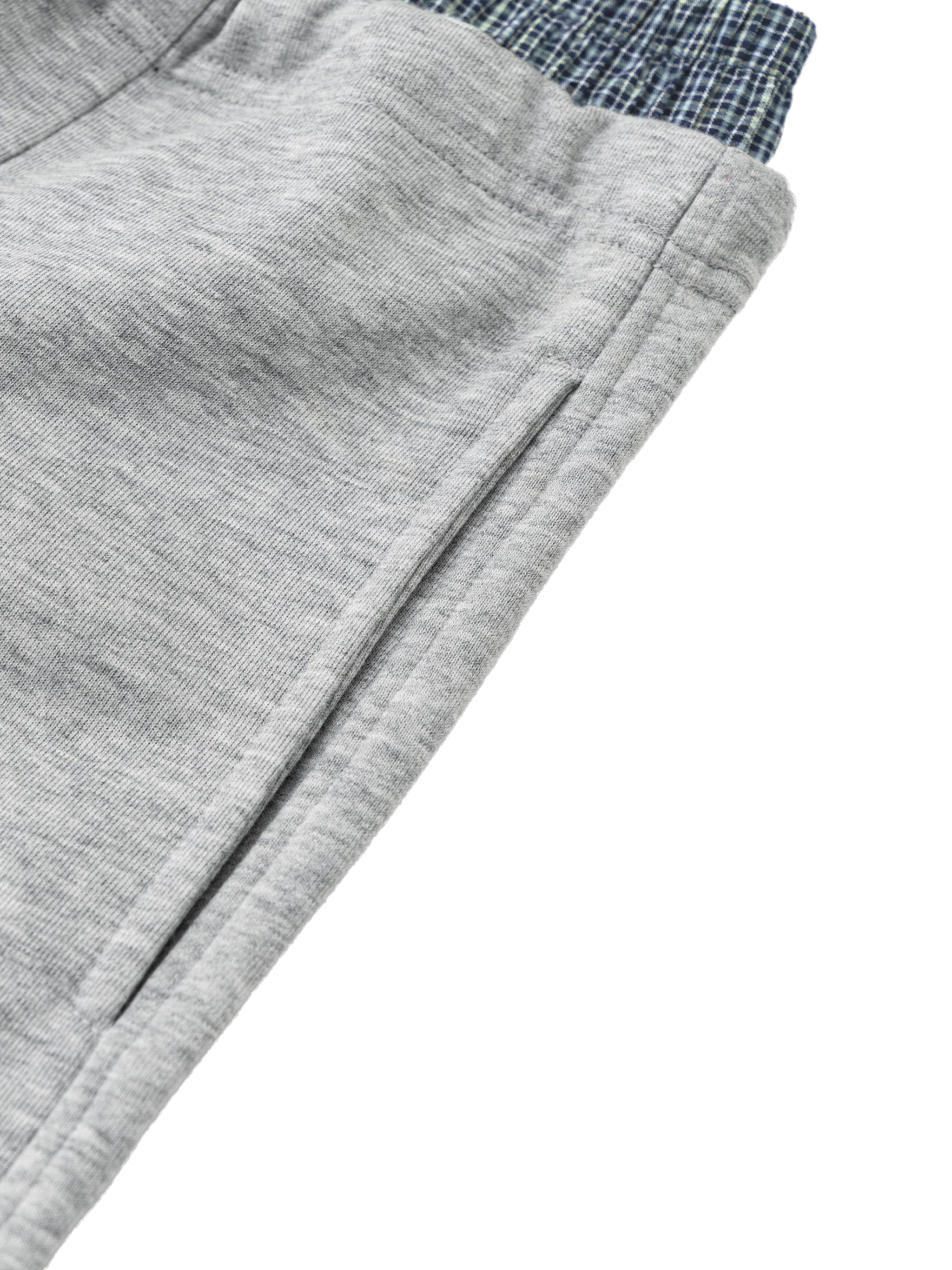 Close-up of gray cotton-polyester blend plaid contrast waist pants with side pocket.