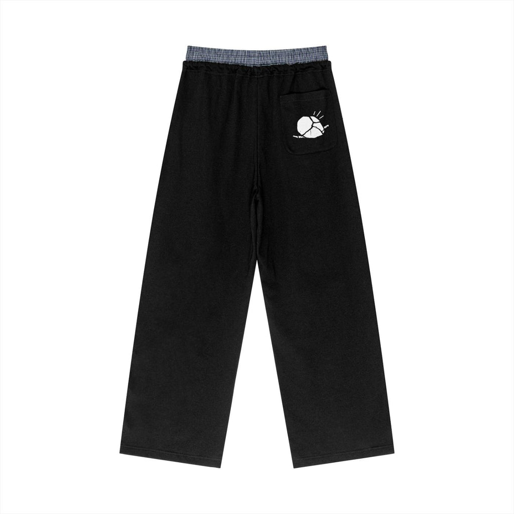 Black unisex plaid contrast waist pants with a white sun graphic on the back pocket.