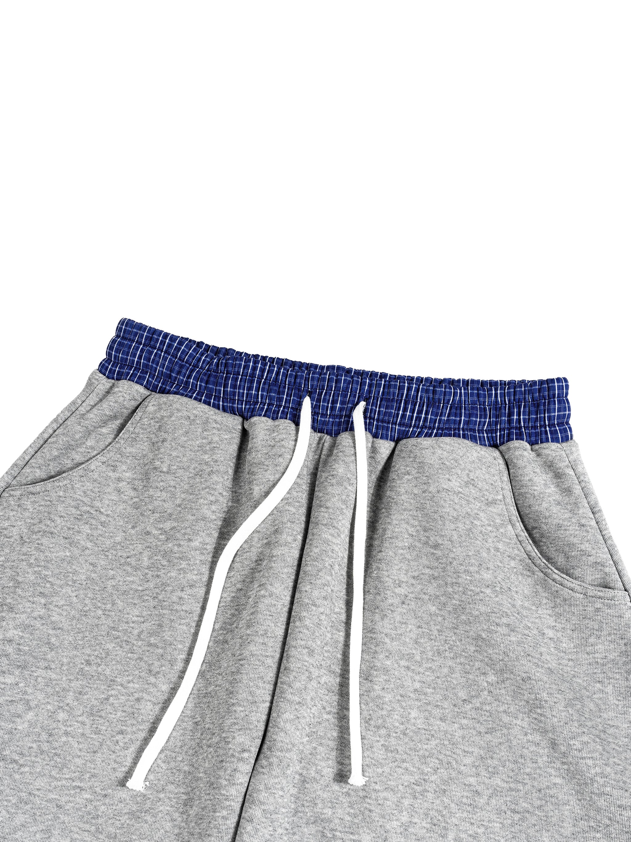 Gray cotton blend barrel sweatpants with a blue plaid elastic waistband and white drawstring.