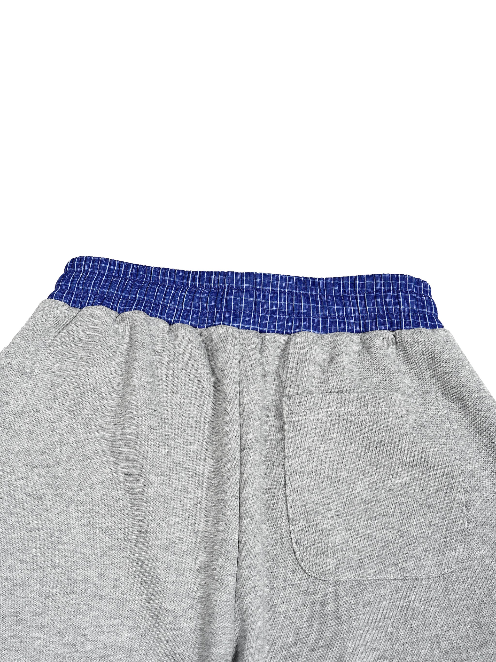 Gray barrel sweatpants with a blue and white plaid elastic waistband and a back patch pocket.