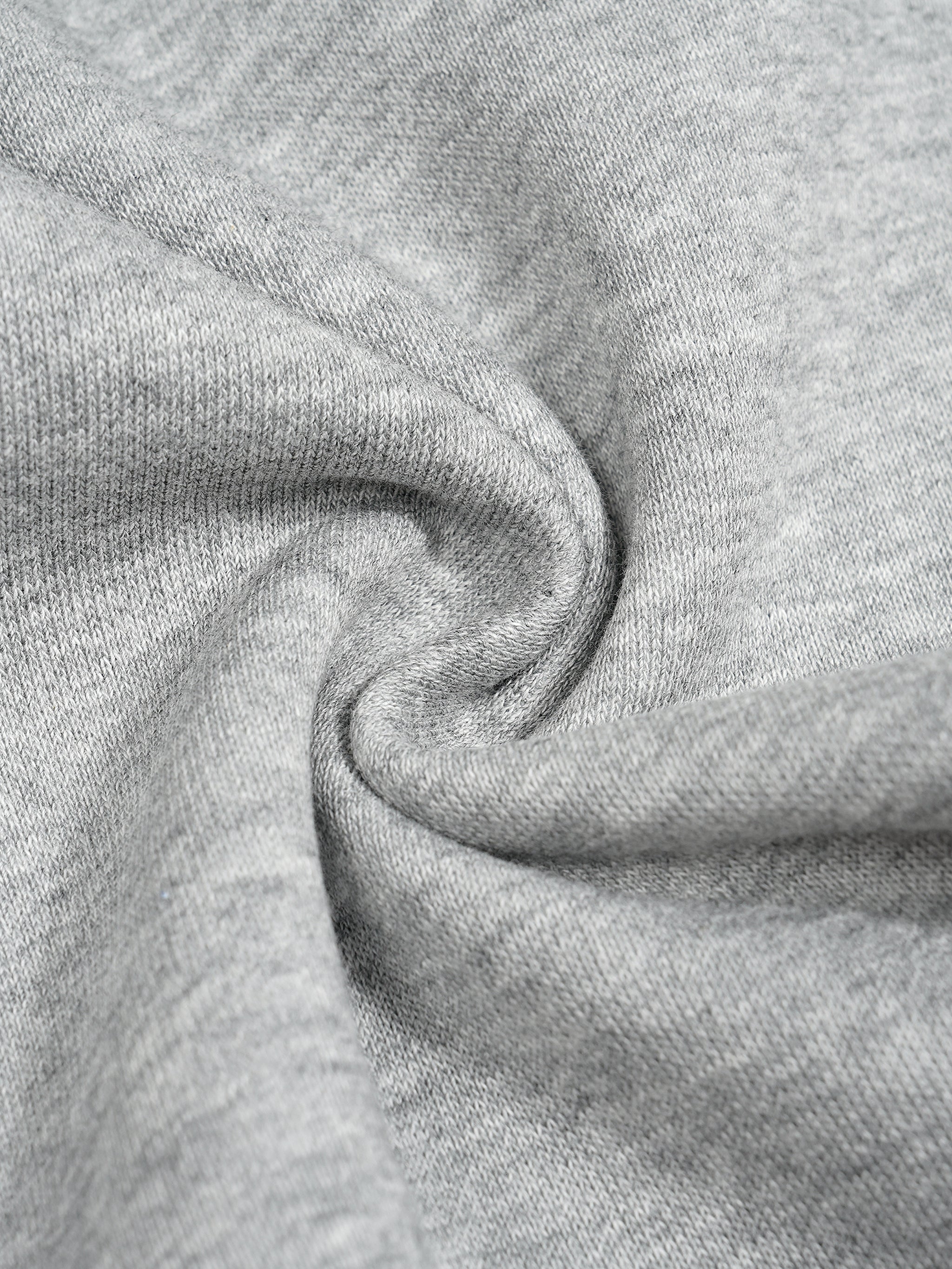 Close-up of thick, heather gray cotton blend fabric with a soft, textured surface, ideal for sweatpants.
