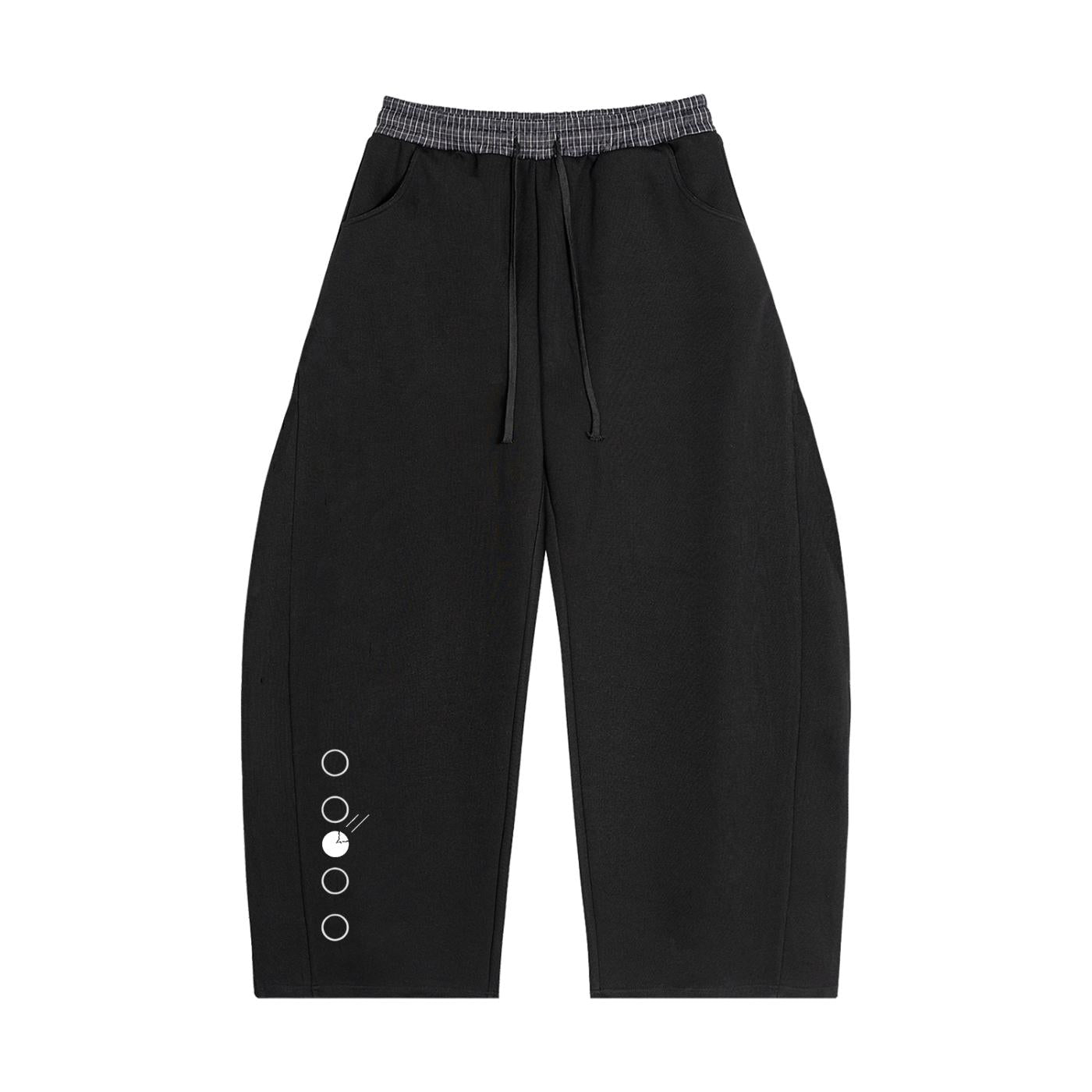 Black barrel sweatpants with a plaid waistband, drawstring, pockets, and decorative metal rings on the left leg.