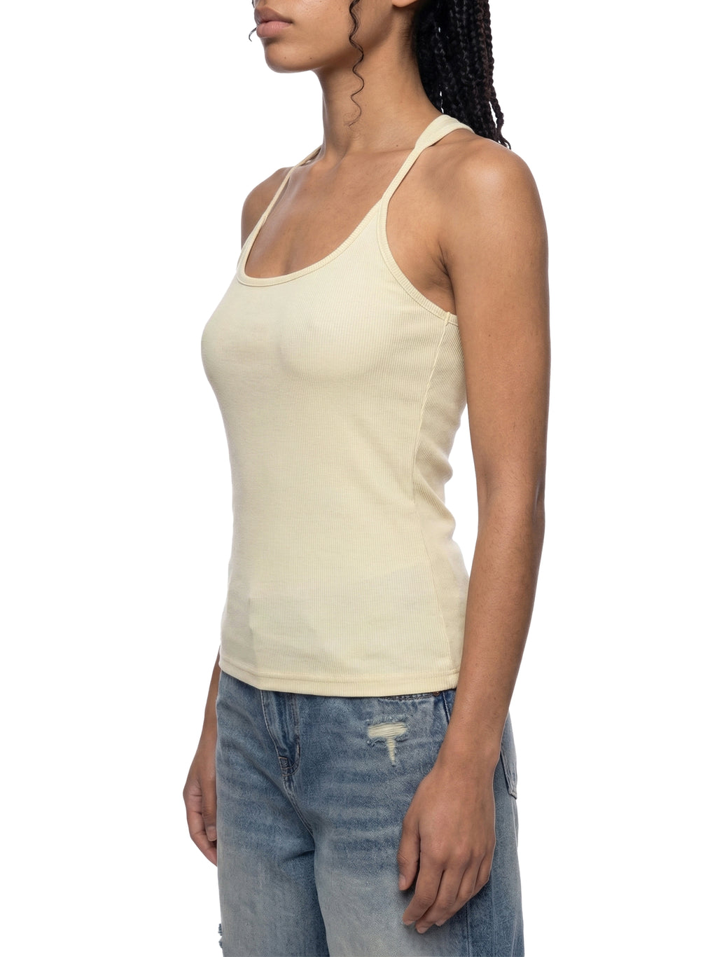 Slim fit ribbed racerback tank top in light yellow cotton blend, paired with distressed blue jeans.