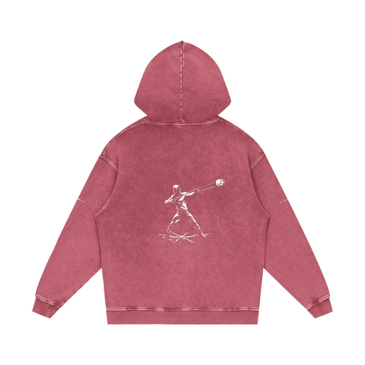 Back of a snow washed loose cotton hoodie in red with a white graphic print of a figure throwing a ball.