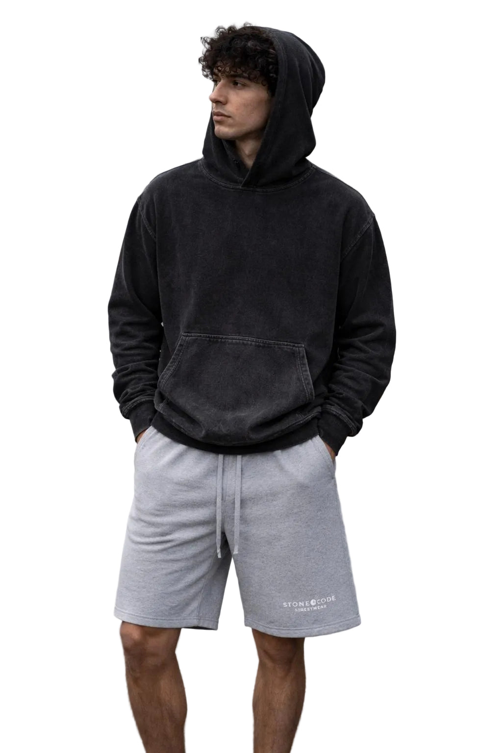 Unisex snow washed loose cotton hoodie in charcoal with a front pocket, worn by a man outdoors.