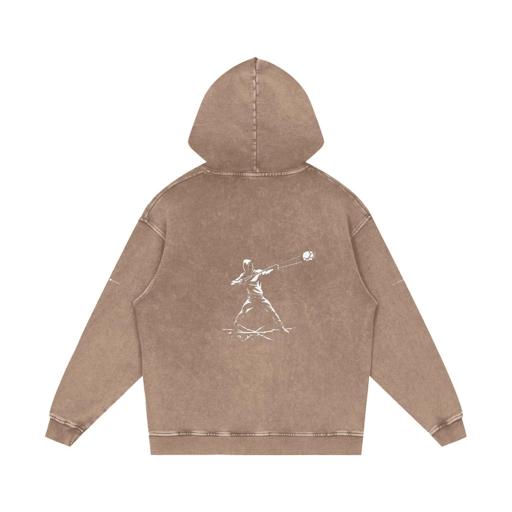 Back of a snow washed loose cotton hoodie in brown with a white graphic print of a figure throwing a ball.