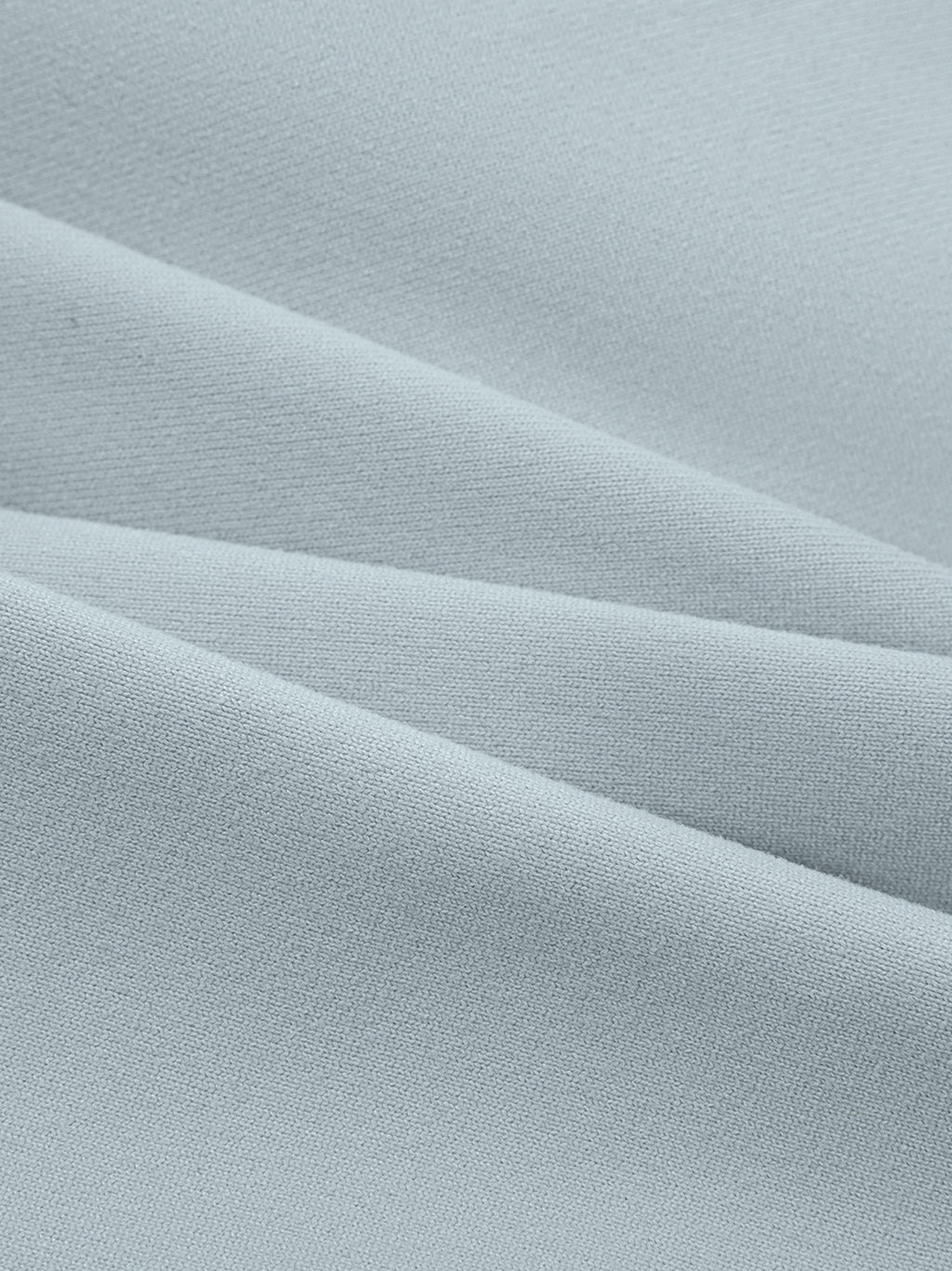 Close-up of light blue, soft, ribbed fabric, likely for a spaghetti strap yoga sports bra.