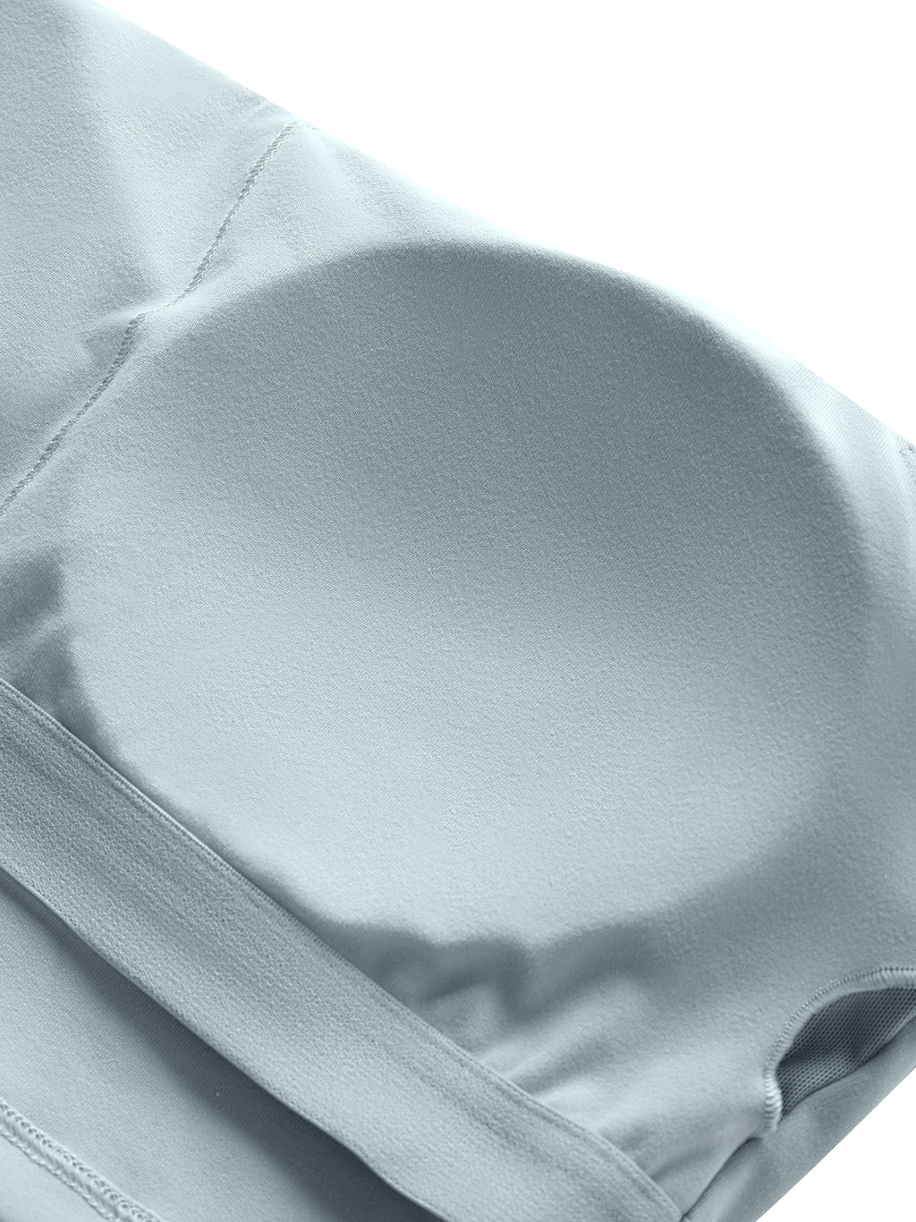 Close-up of a light grey spaghetti strap yoga sports bra, showing the removable padded cup.