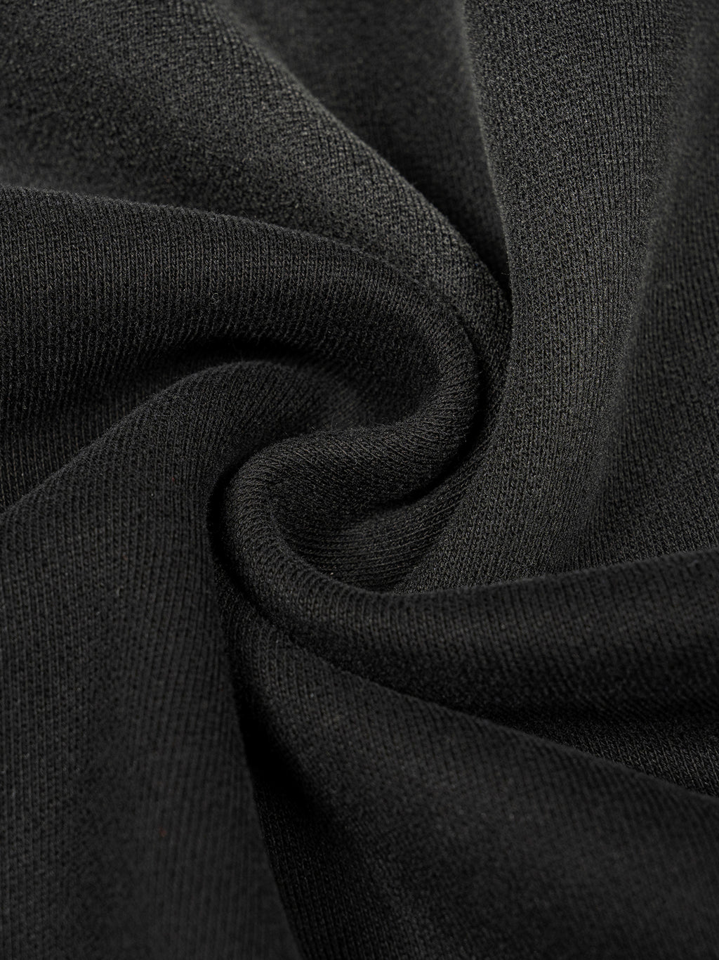 Close-up of a thick, dark gray cotton blend fabric with a washed, sun-faded texture, ideal for a cozy hoodie.