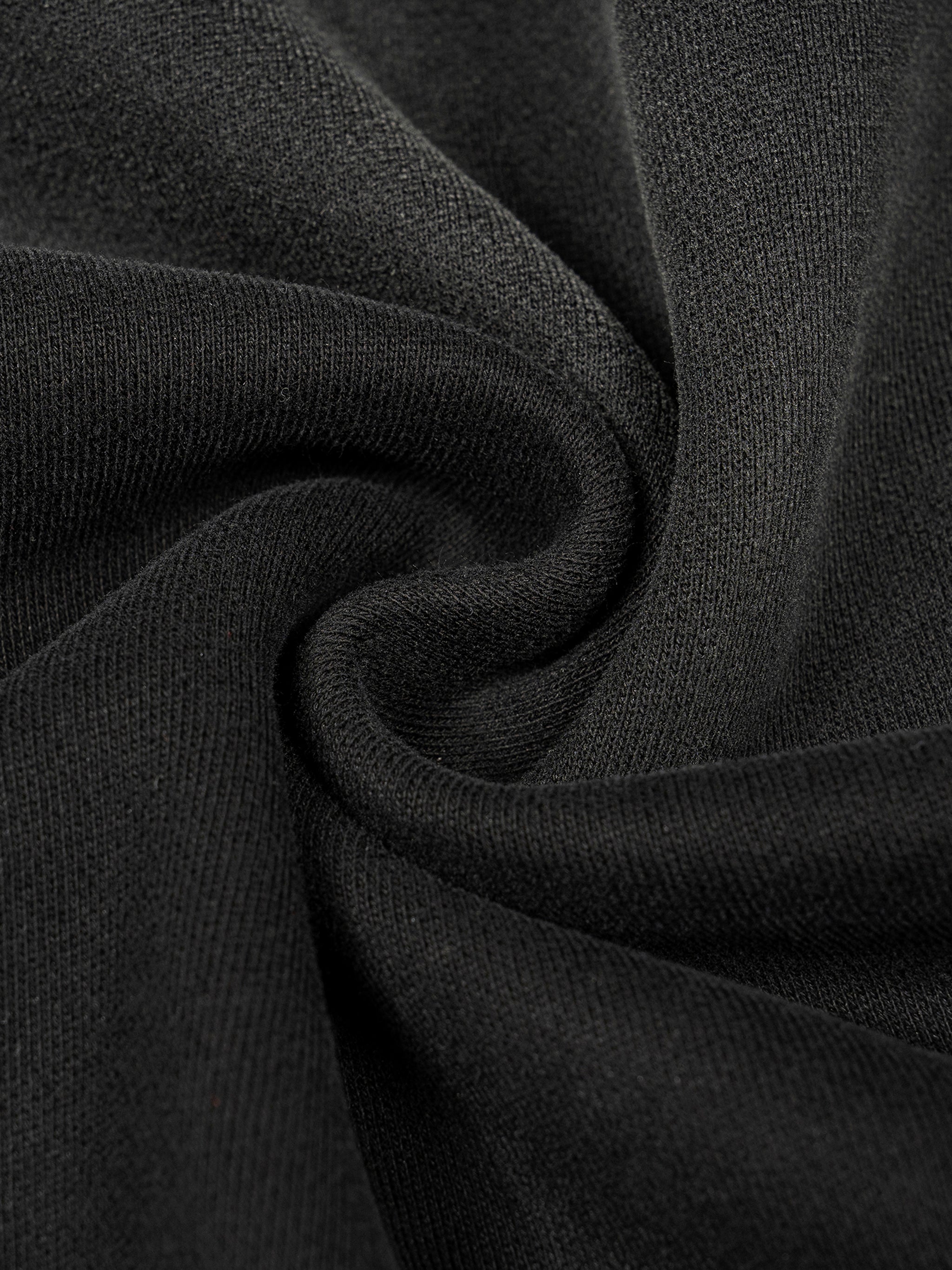 Close-up of a thick, dark gray cotton blend fabric with a washed, sun-faded texture, ideal for a cozy hoodie.